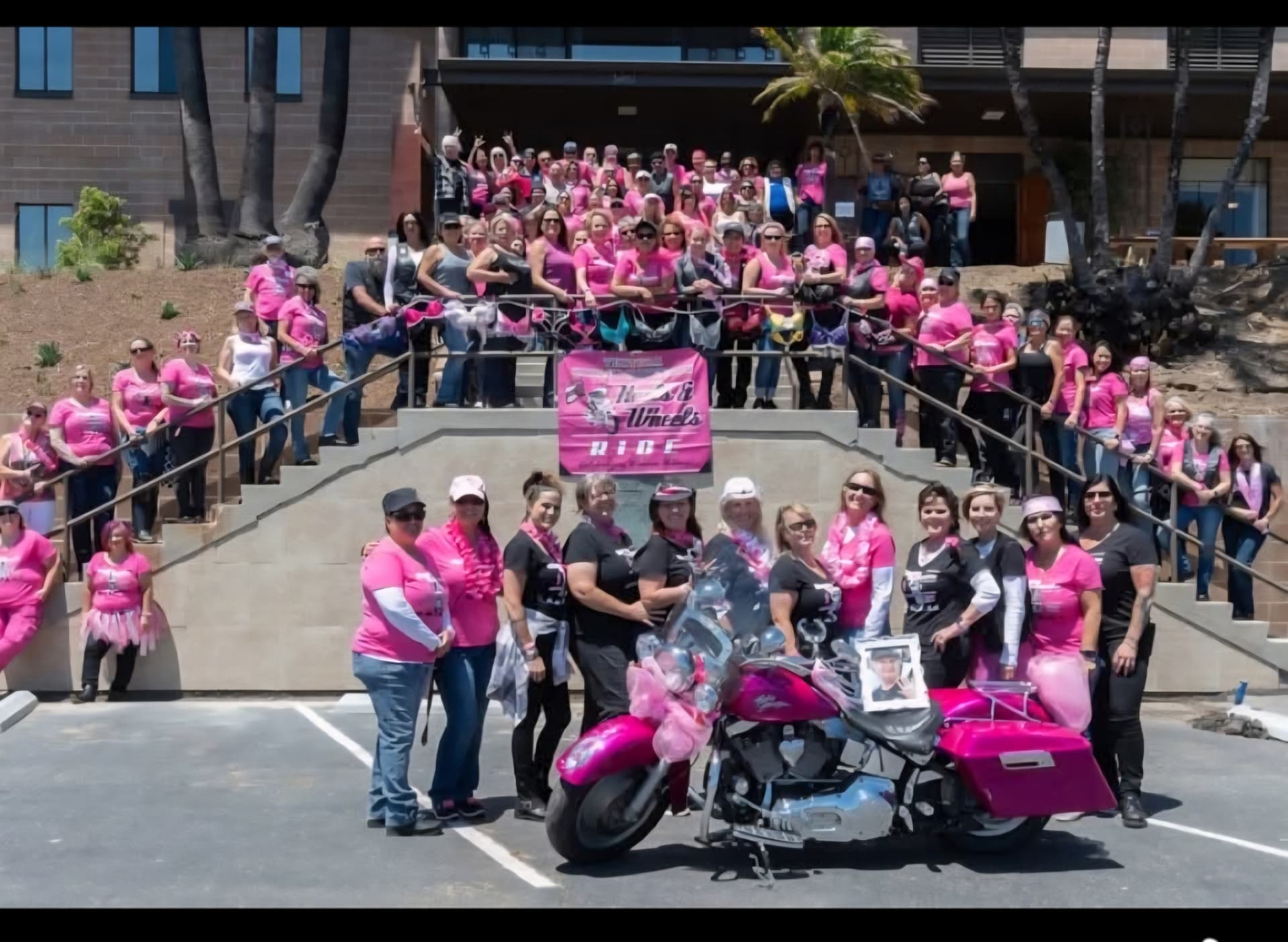 Riders, survivors and supporters gathered with the pink Heels & Wheels motorcycle at a previous Heels & Wheels ride